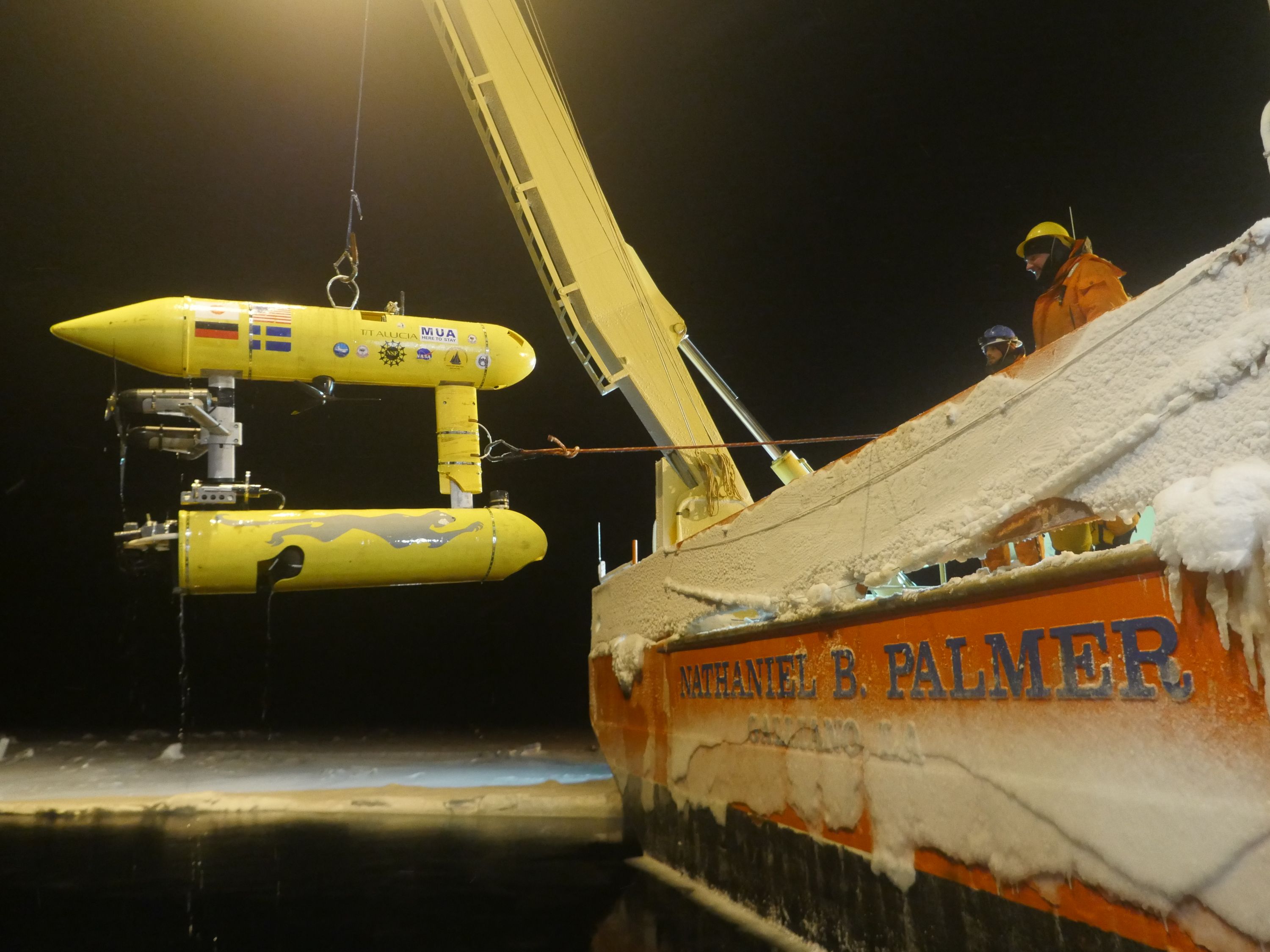 Researchers recover the Jaguar after one of its successful missions collecting sonar data from sea ice.