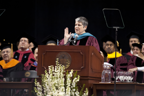 Janet Napolitano in Commencement regalia, speaking at the podium