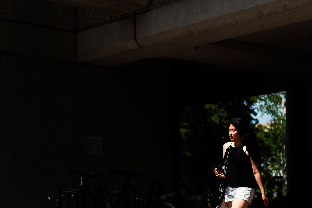 A student walks by Snell Library on June 16, 2016. Photo by Adam Glanzman/Northeastern University