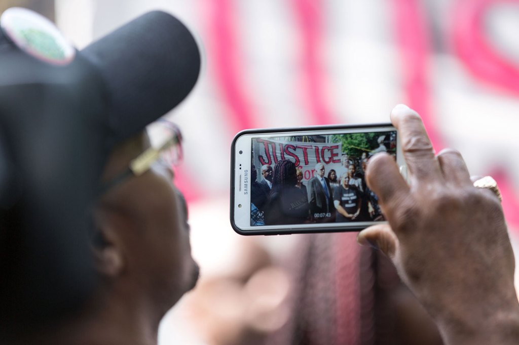 A spectator captures video of Minnesota Gov. Mark Dayton at a press conference on Thursday following the fatal police shooting of Philando Castile in a St. Paul suburb. Photo by Lorie Shaull/Flickr