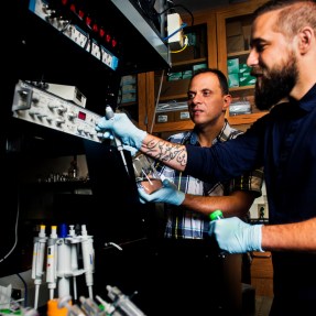 Meni Wanunu, associate professor of physics, and his post doctoral student Robert Henley are using carbon nanotubes as a filter to desalinate water. Their new paper shows the method works better than any other existing process. Photo by Adam Glanzman/Northeastern University