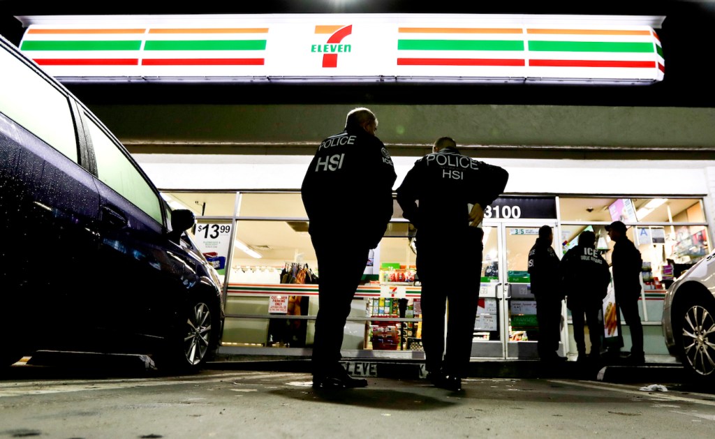 U.S. Immigration and Customs Enforcement agents serve an employment audit notice at a 7-Eleven convenience store Wednesday, Jan. 10, 2018, in Los Angeles. Agents said they targeted about 100 7-Eleven stores nationwide Wednesday to open employment audits and interview workers. (AP Photo/Chris Carlson)