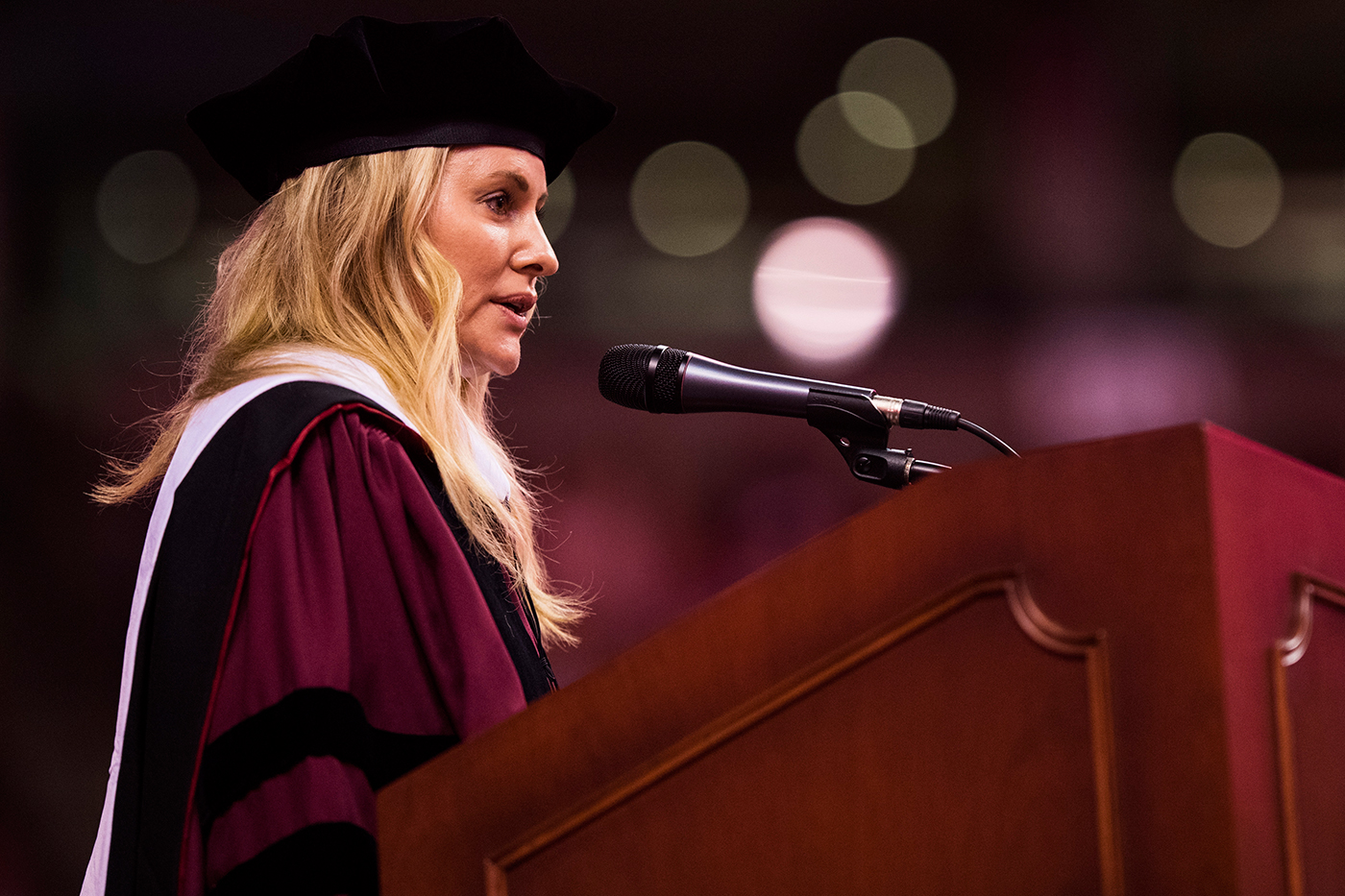 Aimée Mullins speaking at the podium