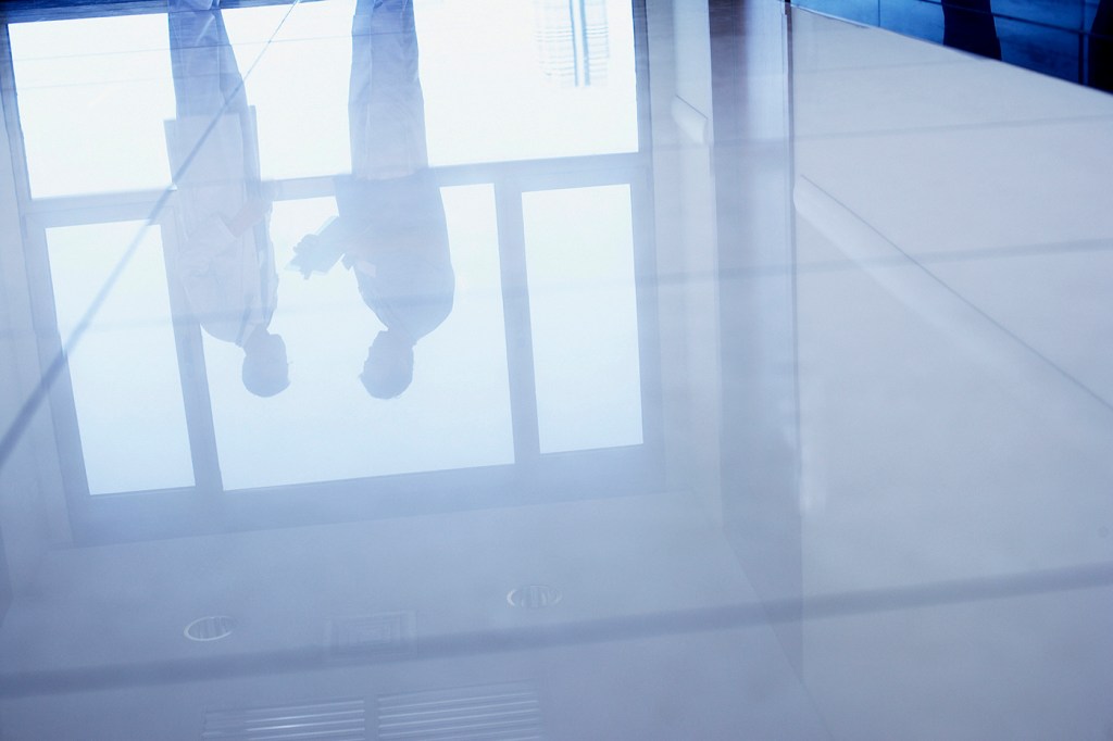 stock image of people standing on a hospital-like floor