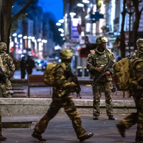 Special Police, Army, and other units move toward the scene in Paris suburb Saint-Denis on Wednesday, Nov. 18, 2015. Heavily armed police surrounded a suburban Paris apartment in a raid targeting the suspected mastermind of the Paris attacks. Credit: KAMIL ZIHNIOGLOU/Sipa via AP Images