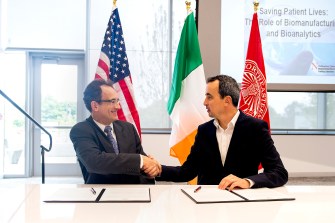 David Luzzi, senior vice provost for research and vice president of Northeastern’s Innovation Campus, and Killian O’Driscoll, who directs projects at the National Institute for Bioprocessing Research, sign a partnership agreement on Tuesday, Sept. 10, 2019. Photo by Matthew Modoono/Northeastern University