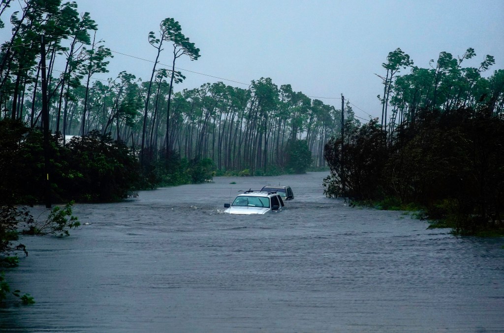 Cars sit submerged in water from Hurricane Dorian in Freeport, Bahamas, Tuesday, Sept. 3, 2019. (AP Photo/Ramon Espinosa)