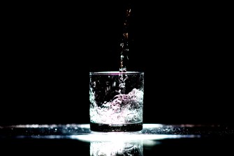 A picture of water dripping into a glass