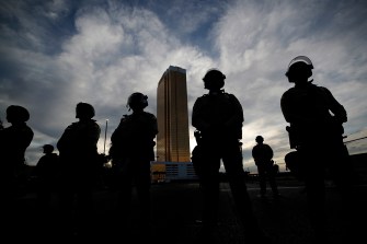 Silhouette of a line of police officers