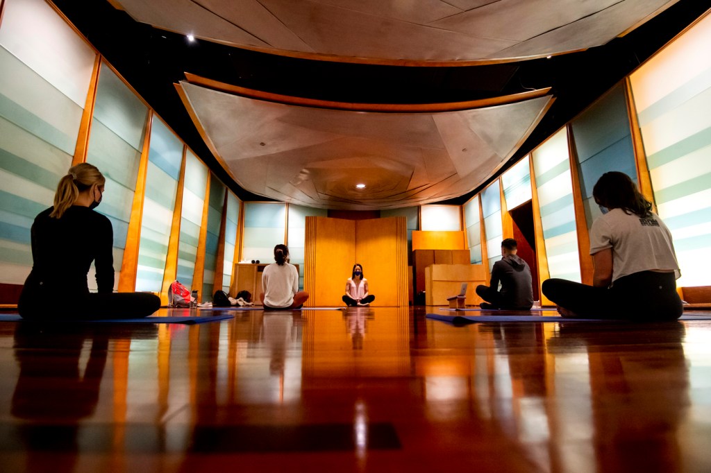 Laura Dudley, assistant clinical professor of applied psychology, teaches yoga during an Introduction to Mindfulness class.