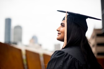 Neha Jain posts in cap and gown.