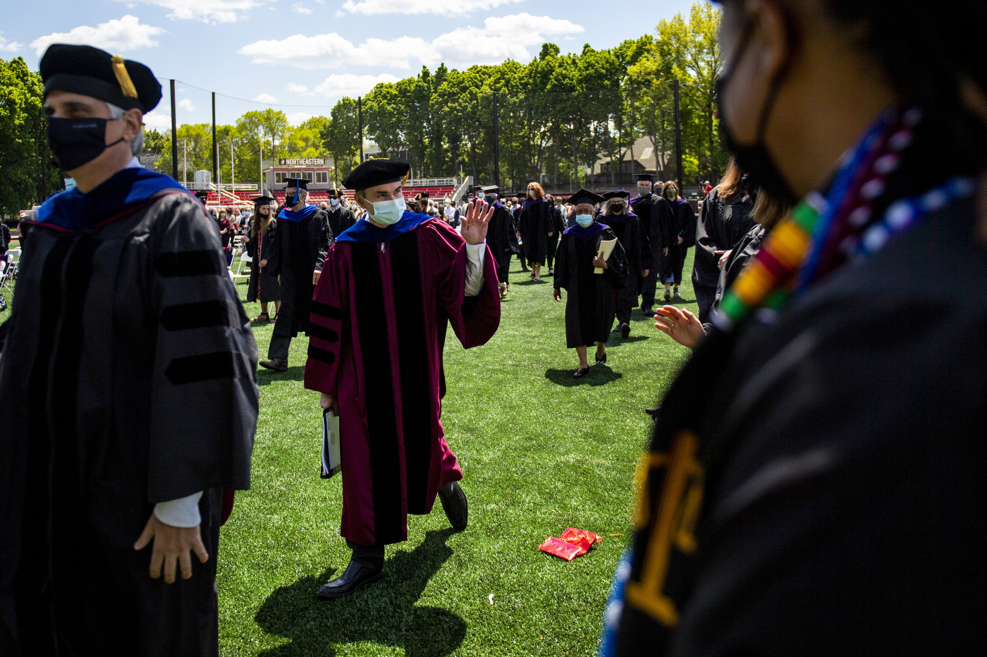 Provost in cap and gown on field