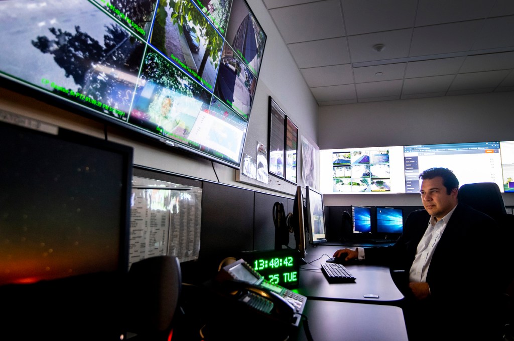 Khushal Safi, associate director of public safety and security at Northeastern, studies a map in the university’s Emergency Operations Center that shows the locations of students, faculty, and staff across the globe—as well as potential safety risks they might face. Photo by Ruby Wallau/Northeastern University