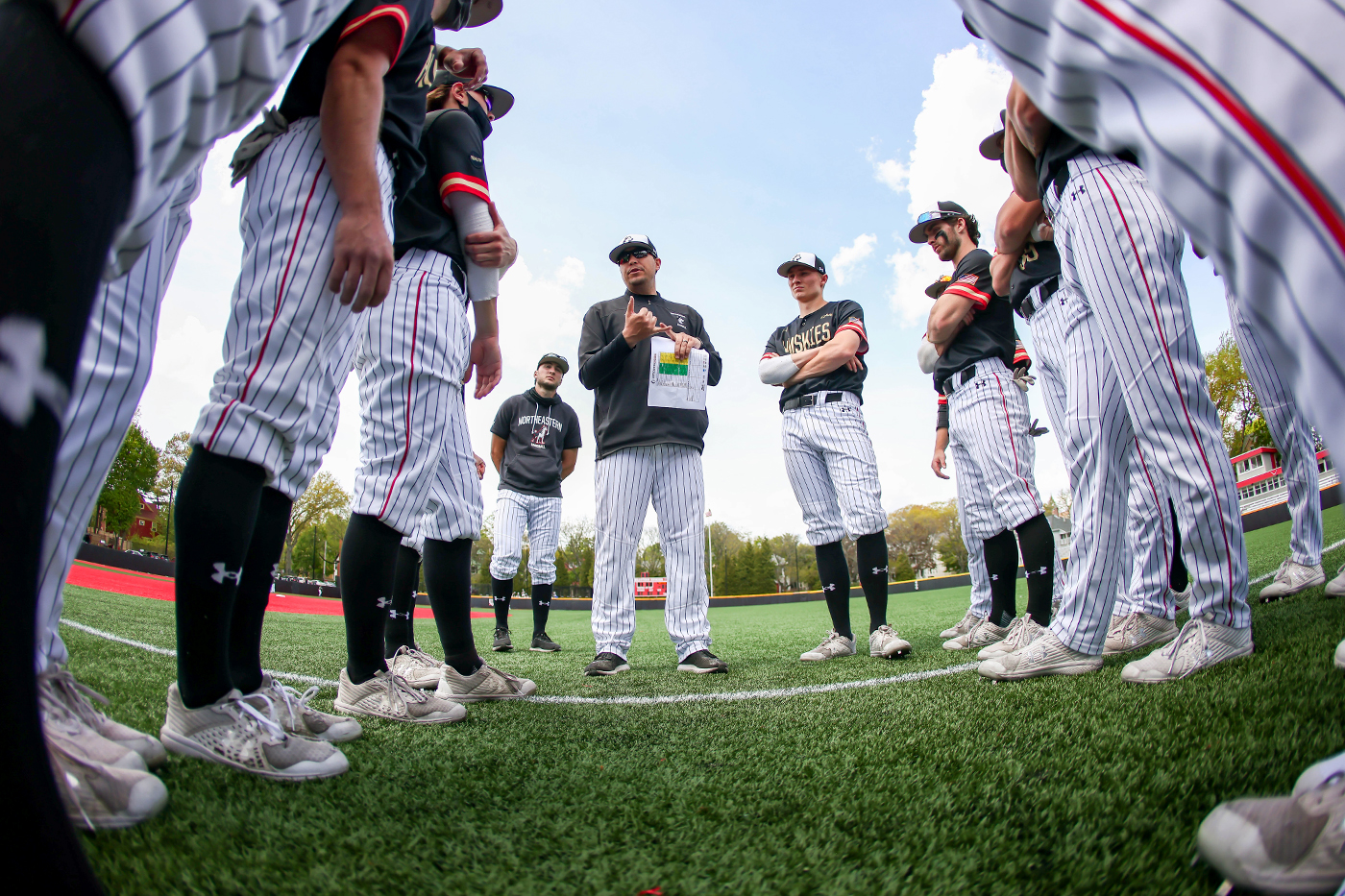 The Huskies baseball team talks as a group.