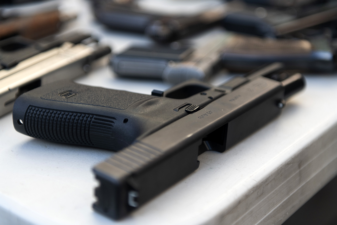 A handgun rests on a table.