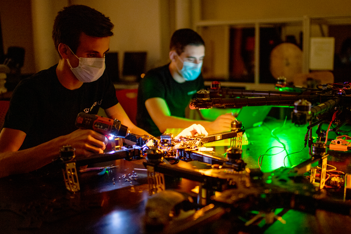 Two students build drones.