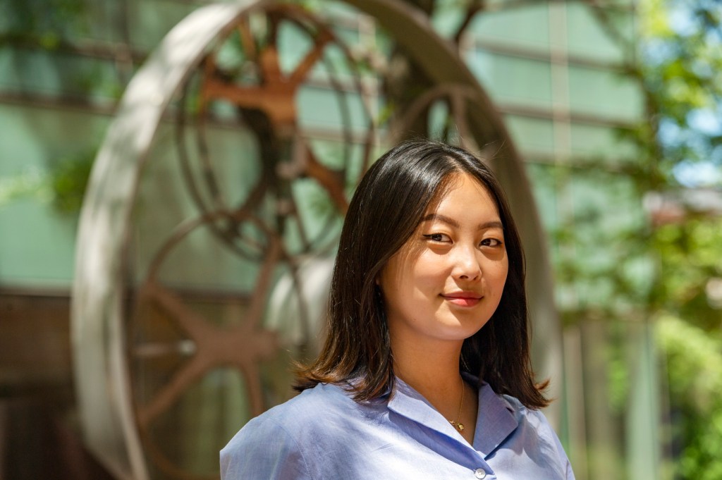 Woman in blue shirt poses for a portrait picture