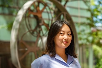 Woman in blue shirt poses for a portrait picture