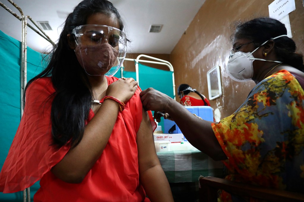 Indian woman receiving a vaccination shot