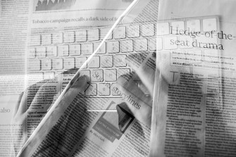 A montage of newspapers eclipsed by a computer keyboard as community journalism moves online