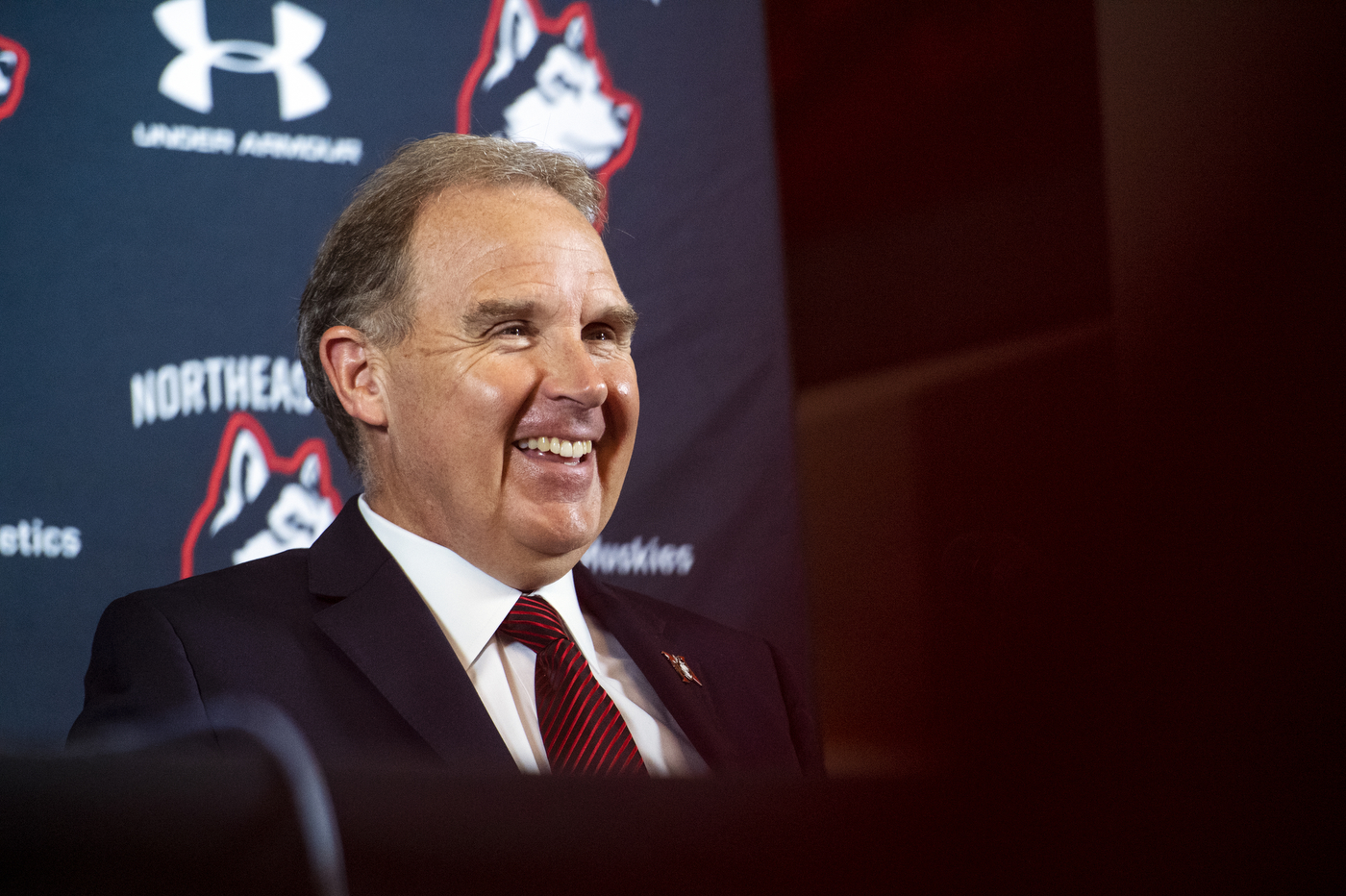 Jim Madigan wearing a suit and tie