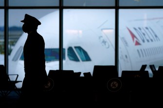 silhouette of a pilot in front of a delta airplane