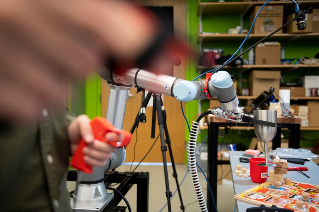 A robotic arm mimics the movements of a human hand