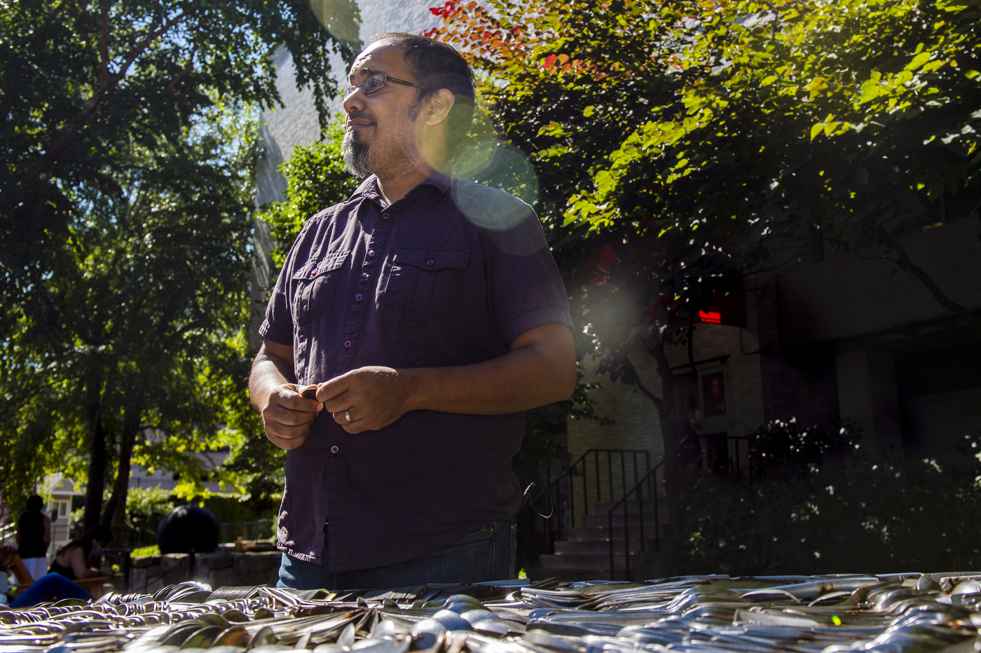 assistant professor rahul bhargava stands in front of art installation