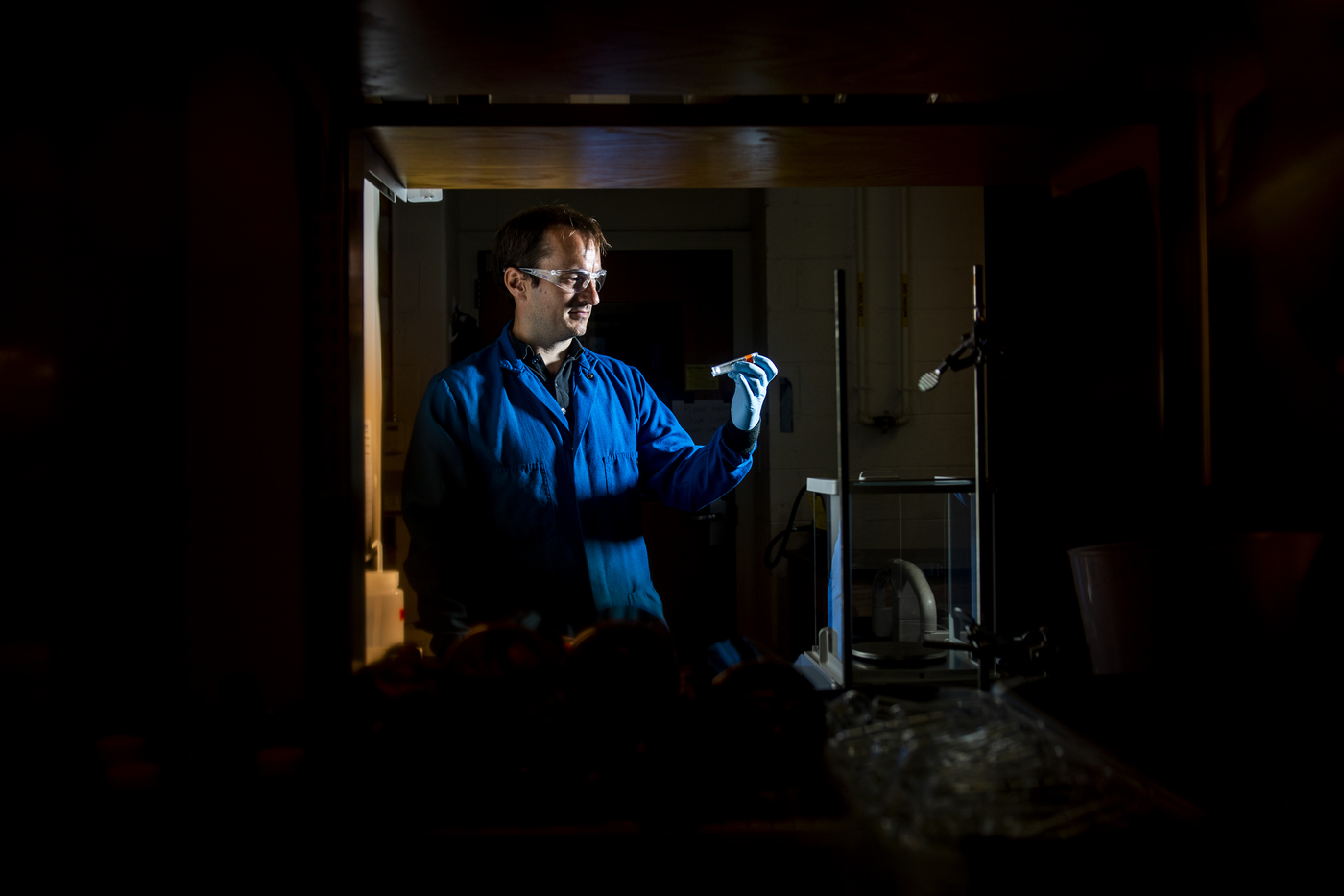 aron stubbins looks at a sample of black carbon