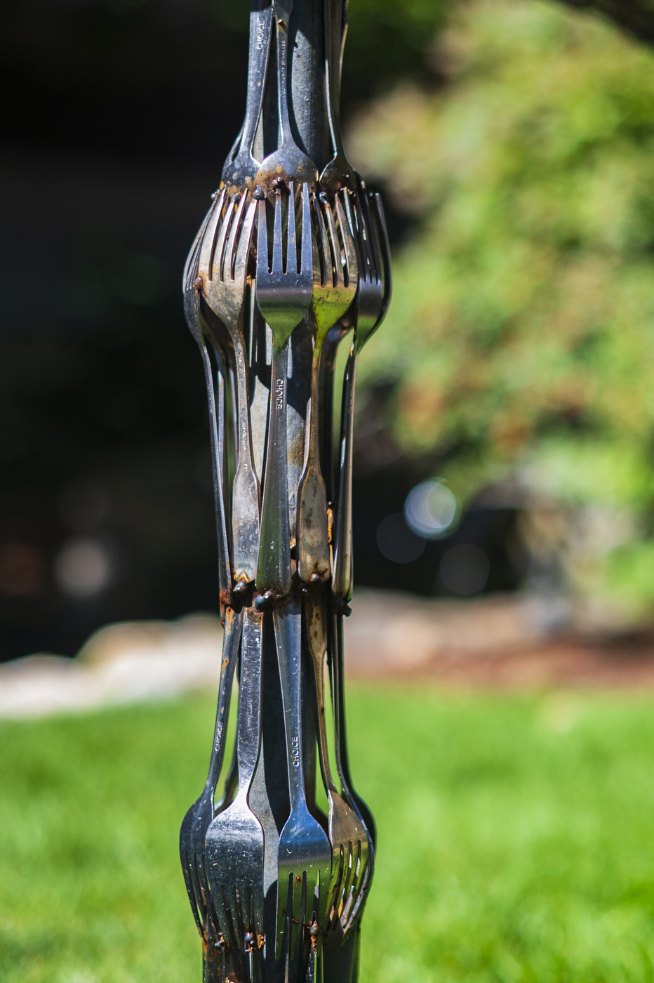 a circle of forks connected at their handle as part of an art installation