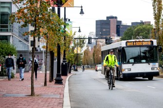 peter furth wearing neon yellow jacket biking down huntington ave