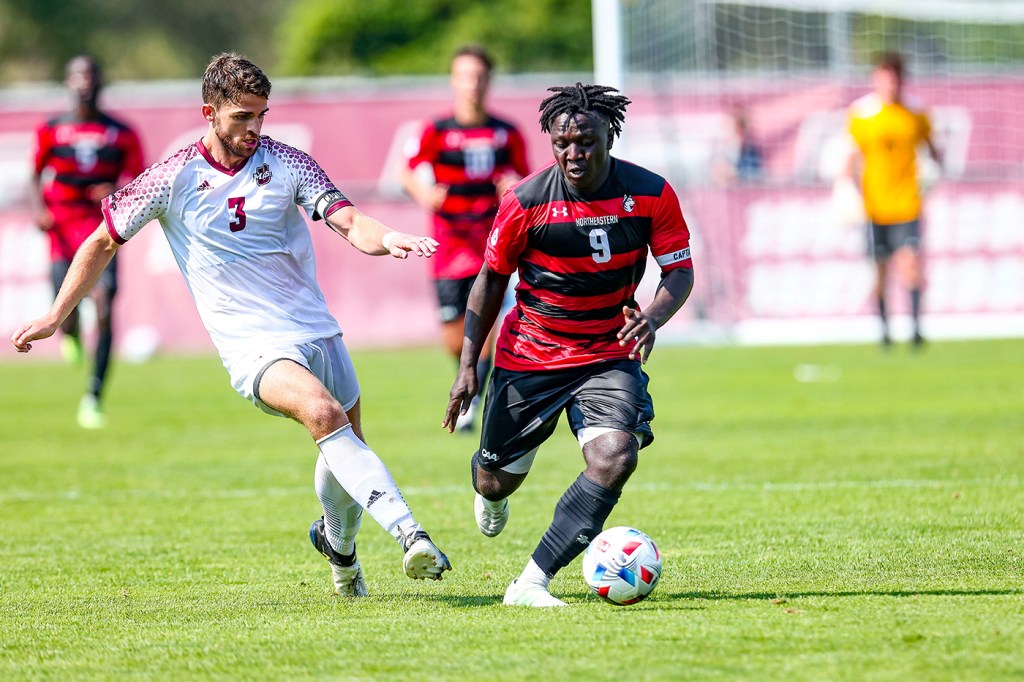 Northeastern's Timothy Ennin dribbles in a soccer game