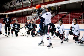 Marco Bozzo, a Huskies forward, celebrates a goal by 8-year-old Simon Valencia-Devin.