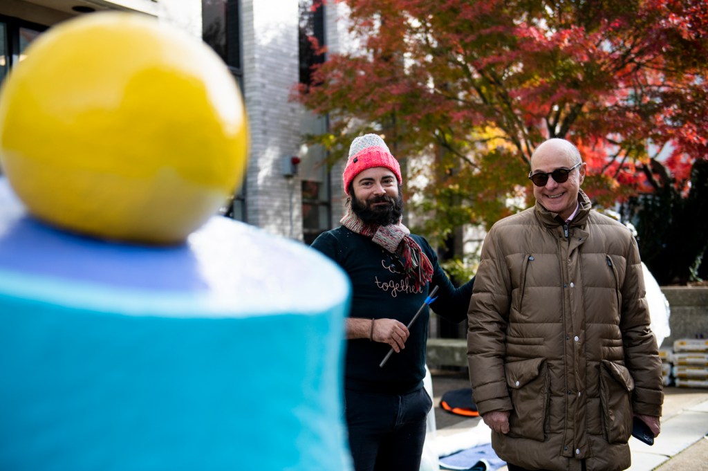 Northeastern President Joseph E. Aoun and artist Adam Frezza take in the new art installation at Richardson Plaza.