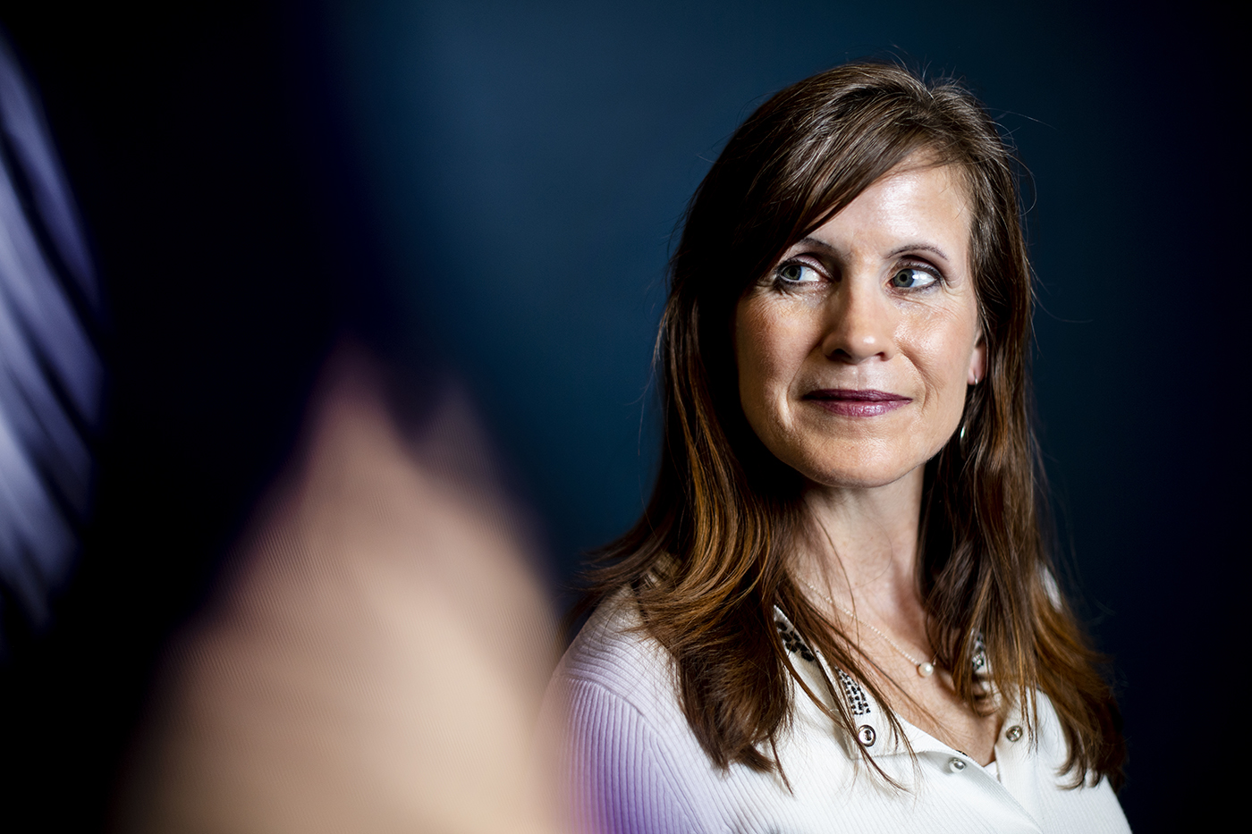 woman with dark hair and white shirt