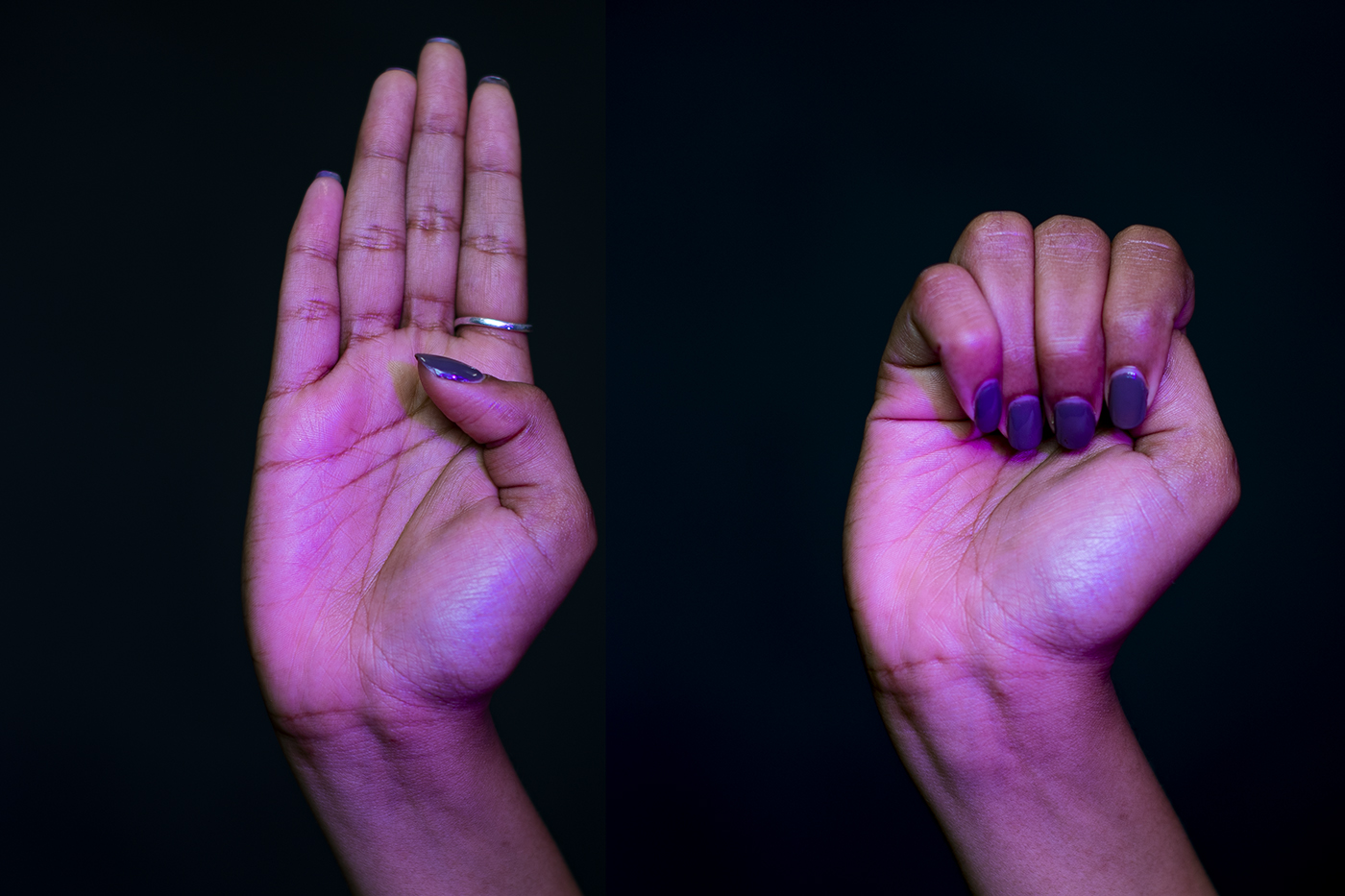 hand showing the domestic violence signal of palm facing forward thumb over palm and the rest of fingers wrapped over thumb