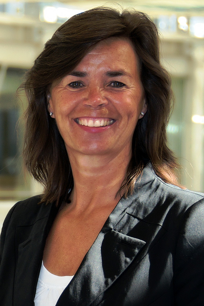 woman wearing white shirt and black blazer smiling