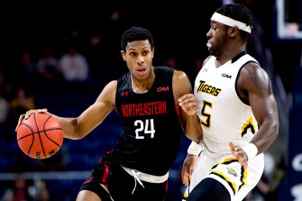 Northeastern's huskies basketball Shaq Walters drives to the basket.