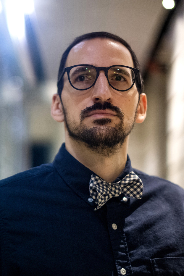 man wearing dark blue button down with bow tie