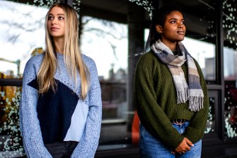 two students standing for a portrait