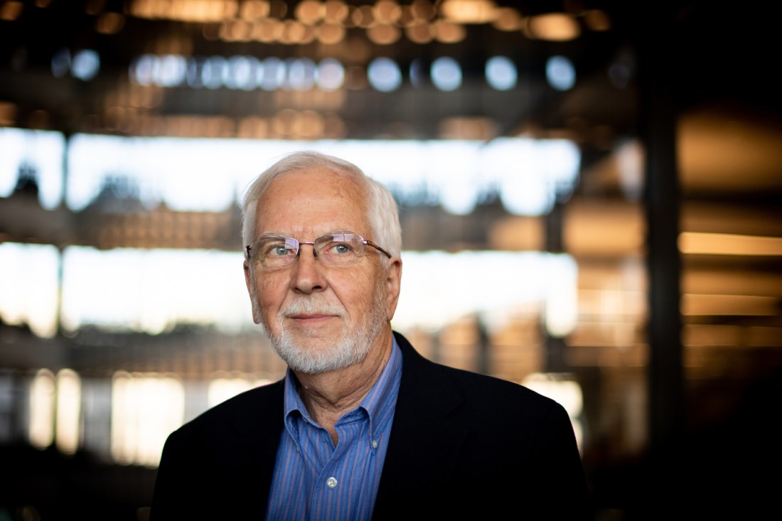 man with white hair and glasses