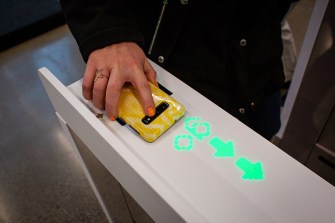 A shopper scans her phone to enter Amazon Go Grocery in Seattle, Washington.