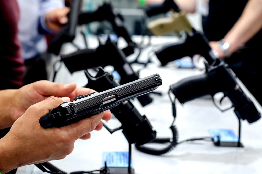 A photo of a gun held in a man's hands.