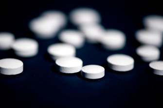 white pills on black background