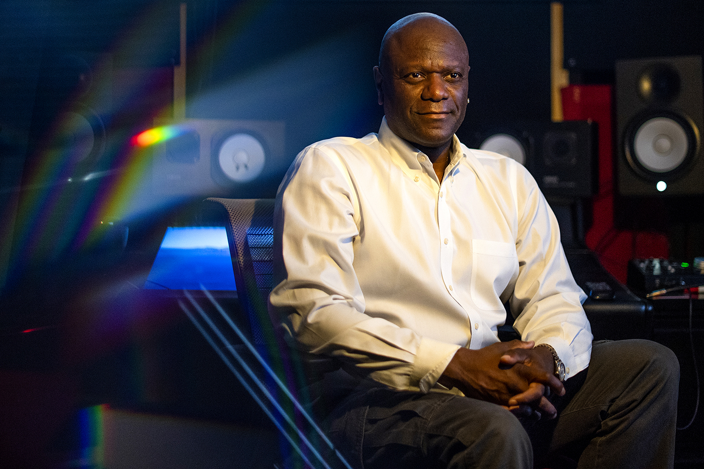 music professor charles alexander sits with his hands folded in his lap