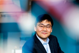 Northeastern assistant physics professor Max Bi poses for a portrait in his office on Huntington Ave. Bi recently earned the Sloan research fellowship.