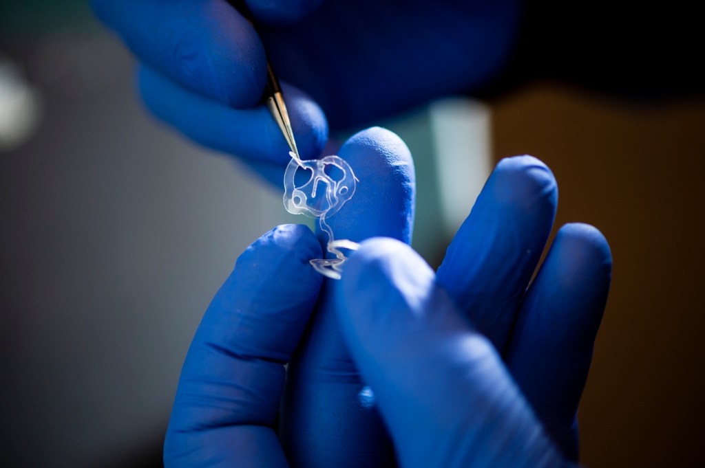 Dan Wilson, a research scientist at Northeastern’s Kostas Research Institute, constructs a wearable UV light sensitive detector.