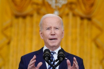 president joe biden speaking at a podium