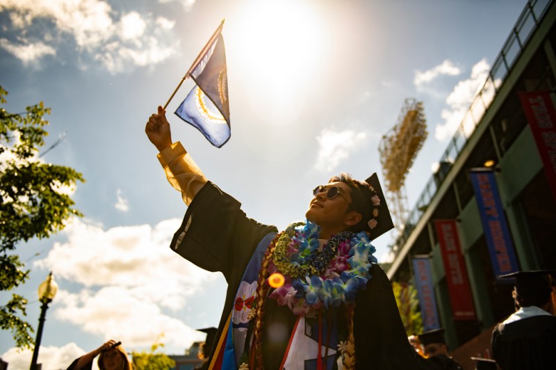 person posing with graduation cap and gown