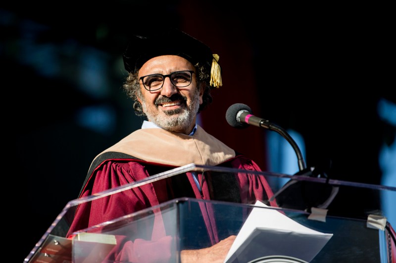 Hamdi Ulukaya in Commencement regalia, speaking at the podium